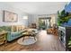 Bright living room featuring hardwood floors, comfortable couch, and access to an outdoor patio at 2526 Clubhouse Dr # 203, Sarasota, FL 34232