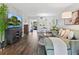 Bright living room features wood floors, comfortable seating, and entertainment center at 2526 Clubhouse Dr # 203, Sarasota, FL 34232