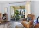 Cozy screened in patio with comfortable chairs and view to the exterior grounds and landscaping at 2526 Clubhouse Dr # 203, Sarasota, FL 34232