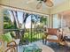 Screened-in patio featuring ceiling fan, tile floor, comfortable seating and view to the exterior grounds at 2526 Clubhouse Dr # 203, Sarasota, FL 34232