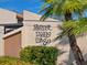 Forest Lakes Village sign with lush landscaping and a stately palm tree at 2526 Clubhouse Dr # 203, Sarasota, FL 34232