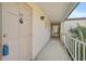 Exterior hallway leading to unit #39 with views of tropical trees at 2851 Swifton Dr # 39, Sarasota, FL 34231