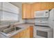Modern kitchen equipped with stainless steel sink and matching appliances at 2851 Swifton Dr # 39, Sarasota, FL 34231