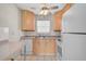 Cozy kitchen featuring wood cabinets, light countertops, and tiled flooring at 2851 Swifton Dr # 39, Sarasota, FL 34231