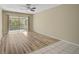 Spacious living room with wood-look flooring and access to the screened in balcony at 2851 Swifton Dr # 39, Sarasota, FL 34231