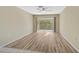 Bright and spacious living room featuring wood-look floors and sliding glass doors at 2851 Swifton Dr # 39, Sarasota, FL 34231