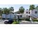 Condo exterior with palm trees, parking, neutral stucco and landscaping at 348 Springdale Dr # 348, Bradenton, FL 34210