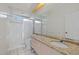 Bathroom featuring a granite countertop vanity with a framed shower and toilet in the background at 402 Pine Ranch East Rd, Osprey, FL 34229