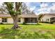 Backyard view showing lanai and lush lawn at 4223 Oakhurst E Cir # 3025, Sarasota, FL 34233