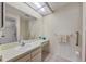 The bathroom has a vanity with a mirror and a tiled shower stall with accessibility handrails at 4223 Oakhurst E Cir # 3025, Sarasota, FL 34233