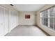 Bright bedroom featuring dual closets, a large window, and neutral wall colors, creating a versatile space at 4223 Oakhurst E Cir # 3025, Sarasota, FL 34233