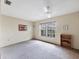 A comfortable bedroom has a large window with natural light, neutral walls, carpet, and a ceiling fan at 4223 Oakhurst E Cir # 3025, Sarasota, FL 34233