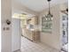 Well-lit kitchen with white appliances, tile flooring, and convenient access to outdoor patio at 4223 Oakhurst E Cir # 3025, Sarasota, FL 34233
