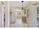 Bright kitchen with white tile flooring, appliances, and charming chandelier at 4223 Oakhurst E Cir # 3025, Sarasota, FL 34233