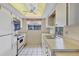 Efficient kitchen with white appliances, tile flooring, and ample counter space at 4223 Oakhurst E Cir # 3025, Sarasota, FL 34233