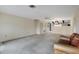 Open-concept living room with neutral carpet and ceiling fan at 4223 Oakhurst E Cir # 3025, Sarasota, FL 34233