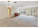 Inviting living room featuring neutral carpet with a ceiling fan and direct front door access at 4223 Oakhurst E Cir # 3025, Sarasota, FL 34233