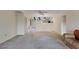 Spacious living room featuring neutral carpet with a ceiling fan, adjacent to the dining area at 4223 Oakhurst E Cir # 3025, Sarasota, FL 34233