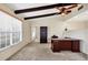 This living room features exposed beams, a ceiling fan, large windows and a wooden desk with shelving at 4223 Oakhurst E Cir # 3025, Sarasota, FL 34233