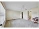 A bright main bedroom with neutral walls, carpet flooring, and a ceiling fan and ensuite bathroom at 4223 Oakhurst E Cir # 3025, Sarasota, FL 34233