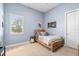 A small bedroom with a twin bed, side table, and window at 4790 Pastel Ct, Sarasota, FL 34240