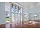 Light-filled dance studio with wood floors, high ceilings, and a wall of mirrors for fitness and recreational activities at 4790 Pastel Ct, Sarasota, FL 34240