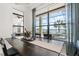 Elegant dining room with large windows offering scenic views of the pool and outdoor landscape at 4790 Pastel Ct, Sarasota, FL 34240