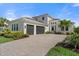 Beautiful exterior of a well-maintained home boasting a three-car garage and a lush, landscaped yard at 4790 Pastel Ct, Sarasota, FL 34240