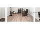 A home office featuring a dark wood desk, exercise equipment, and light wood floors at 4790 Pastel Ct, Sarasota, FL 34240
