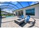 Stylish outdoor patio with a fire pit, comfortable seating, and a screened pool area, ideal for entertaining or relaxing at 4790 Pastel Ct, Sarasota, FL 34240