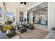 Covered patio with comfortable seating and a view into the modern living room and kitchen through sliding glass doors at 4790 Pastel Ct, Sarasota, FL 34240