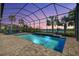 Enclosed pool area with a brick patio, lounge chairs, and scenic lake views at dusk for relaxation and entertainment at 4790 Pastel Ct, Sarasota, FL 34240