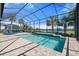Screened pool with brick patio overlooking a serene lake view and lush landscaping, perfect for relaxation and outdoor enjoyment at 4790 Pastel Ct, Sarasota, FL 34240