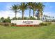 Community entrance sign with colorful landscaping and lush green grass at 4790 Pastel Ct, Sarasota, FL 34240