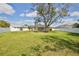 Spacious backyard includes fenced perimeter, mature shade tree, and pool with screened enclosure at 4920 Breakwater Dr, Bradenton, FL 34203