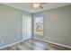 Bright bedroom with wood-look floors, a window view, a ceiling fan and a closet at 4920 Breakwater Dr, Bradenton, FL 34203