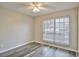 Cozy bedroom with neutral walls, wood-look floors, a ceiling fan, and a bright window at 4920 Breakwater Dr, Bradenton, FL 34203