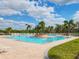 Large community pool with ample lounge chairs, palm trees, and a spacious deck area for residents to relax and enjoy at 4920 Breakwater Dr, Bradenton, FL 34203