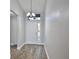 Bright entryway featuring wood-look flooring, a chandelier, and a window above the front door at 4920 Breakwater Dr, Bradenton, FL 34203