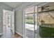 Hallway with view of screened-in pool area, and wood-look tile flooring at 4920 Breakwater Dr, Bradenton, FL 34203