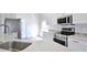 Close-up of a modern kitchen with stainless steel appliances and white countertops at 4920 Breakwater Dr, Bradenton, FL 34203