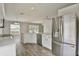 Bright kitchen with white cabinets, stainless steel appliances, and breakfast bar area at 4920 Breakwater Dr, Bradenton, FL 34203