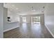 Open-concept living room featuring wood-look tile flooring and sliding glass doors leading to the backyard at 4920 Breakwater Dr, Bradenton, FL 34203
