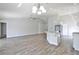 Open-concept living room and kitchen boasts wood-look floors and modern lighting fixtures at 4920 Breakwater Dr, Bradenton, FL 34203