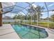 Sparkling pool is surrounded by a screened enclosure and fenced-in backyard at 4920 Breakwater Dr, Bradenton, FL 34203