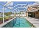 Private screened-in pool offers refreshing retreat with views of lush backyard landscaping at 4920 Breakwater Dr, Bradenton, FL 34203