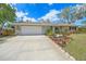 Well-maintained single-story home with a two-car garage, landscaped front yard, and concrete driveway at 5322 Ruby Ln, Sarasota, FL 34231