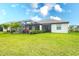 Well-manicured backyard with a screened in patio and beautiful lush green grass at 5433 Mystic Water Cv, Lakewood Ranch, FL 34211