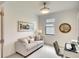 Charming bedroom with a sofa, desk, modern lighting, neutral colors and carpet flooring at 5433 Mystic Water Cv, Lakewood Ranch, FL 34211