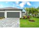 Lovely home exterior with a brick driveway, well-maintained lawn, and beautiful landscaping at 5433 Mystic Water Cv, Lakewood Ranch, FL 34211